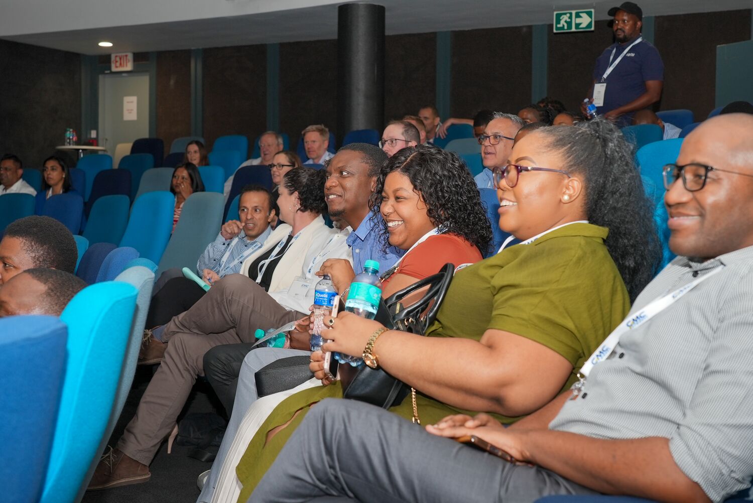 A wide view of employees seated in the auditorium