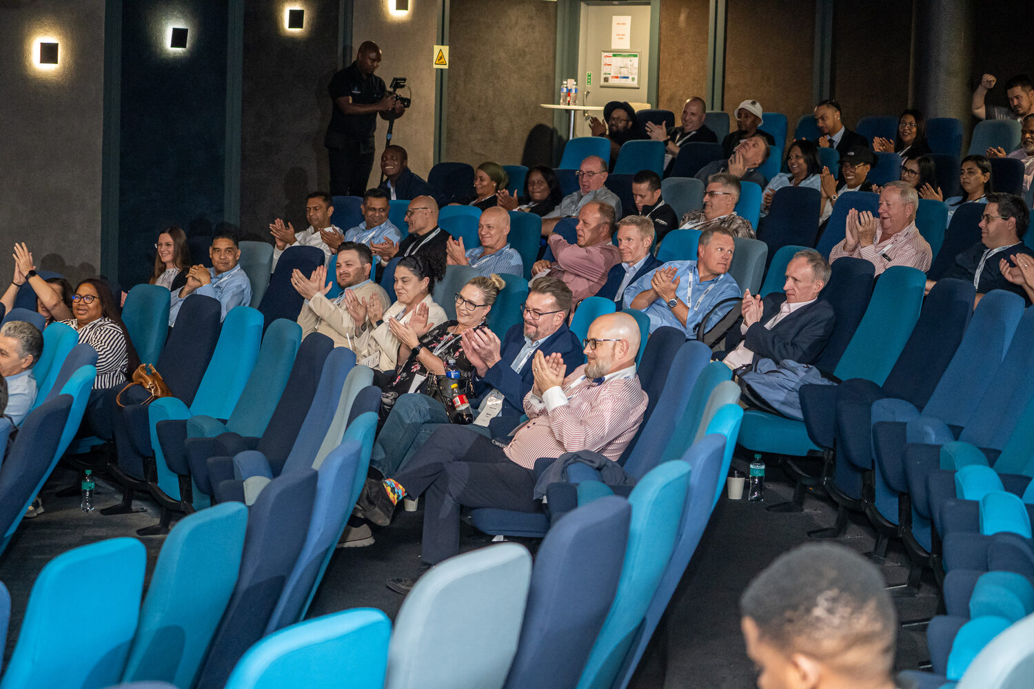The audience applauding during a 2026 session