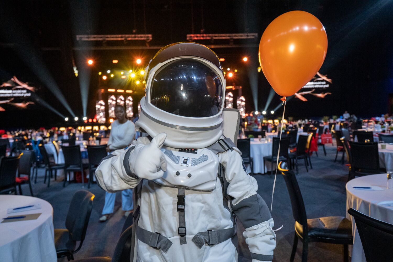 An astronaut mascot on the event floor
