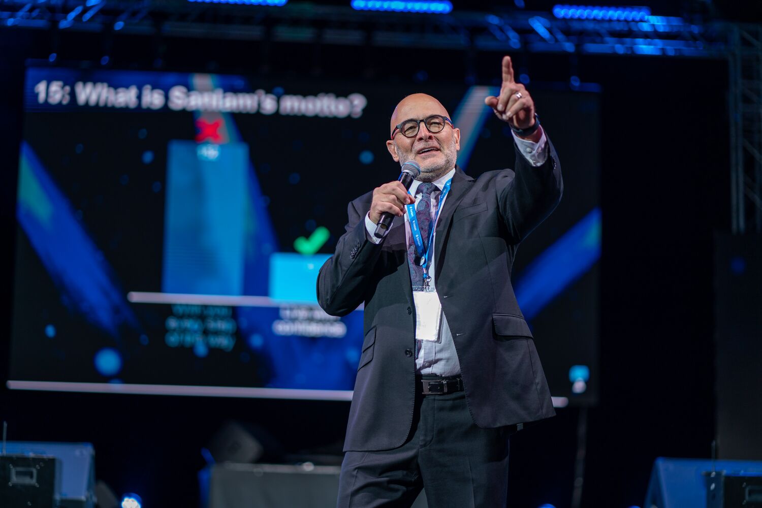 A presenter addressing the audience on stage