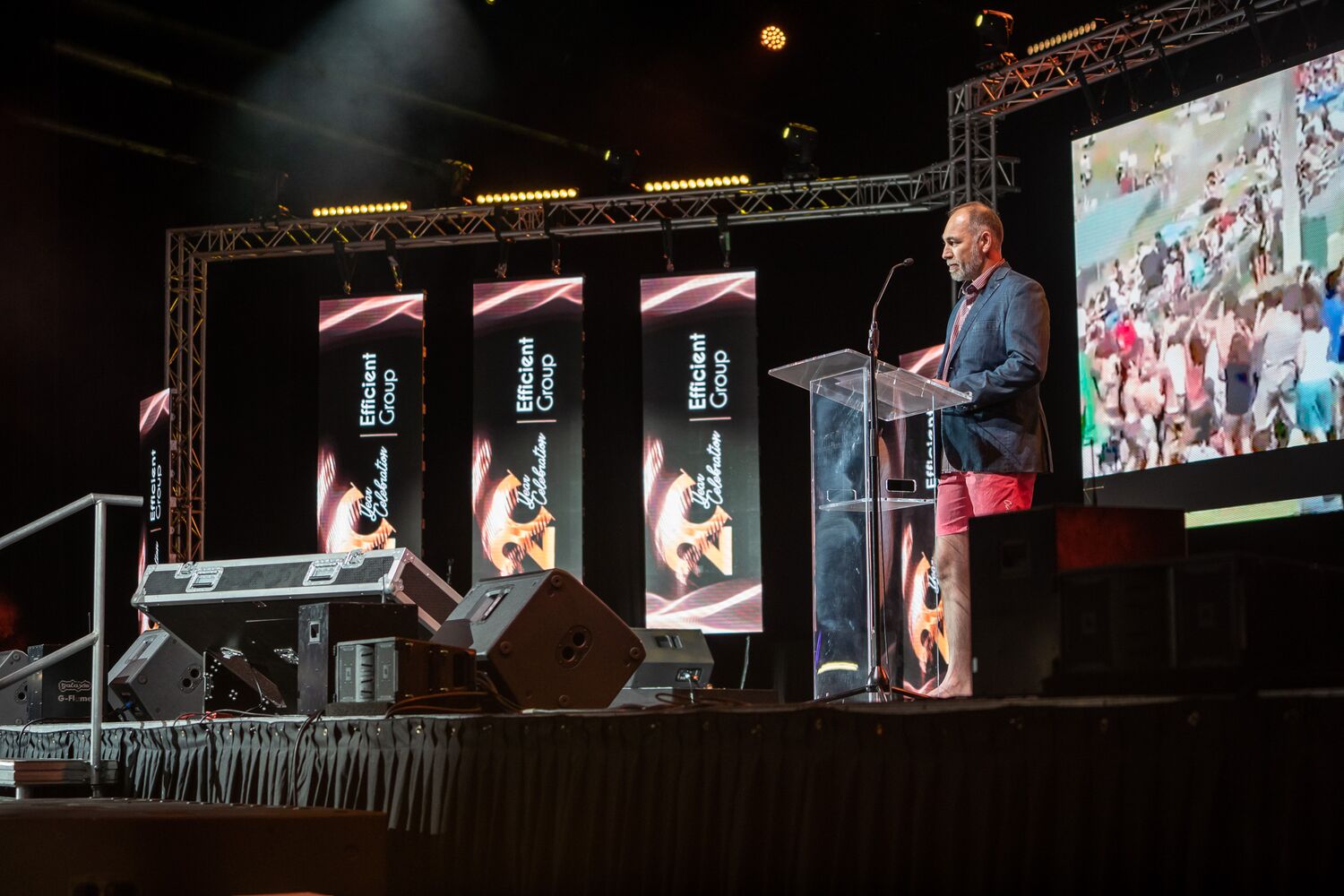 A speaker presenting to the arena audience