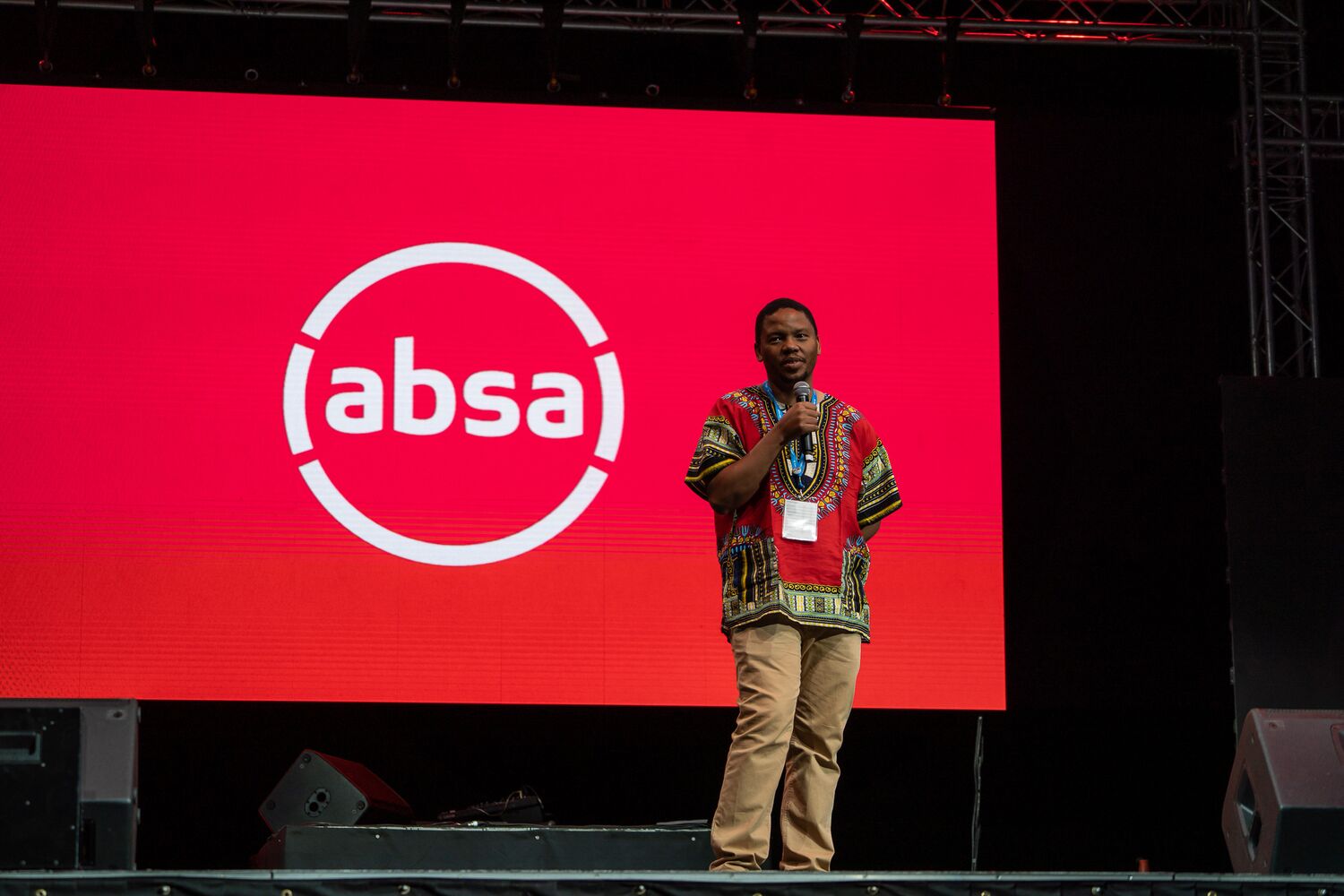A presenter on stage during a sponsor segment