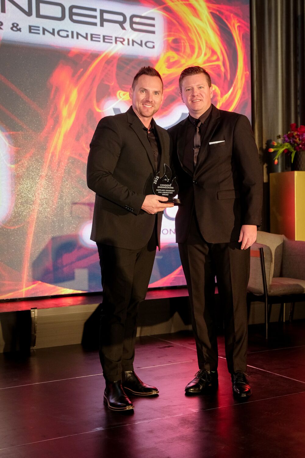 An employee receiving an award on stage