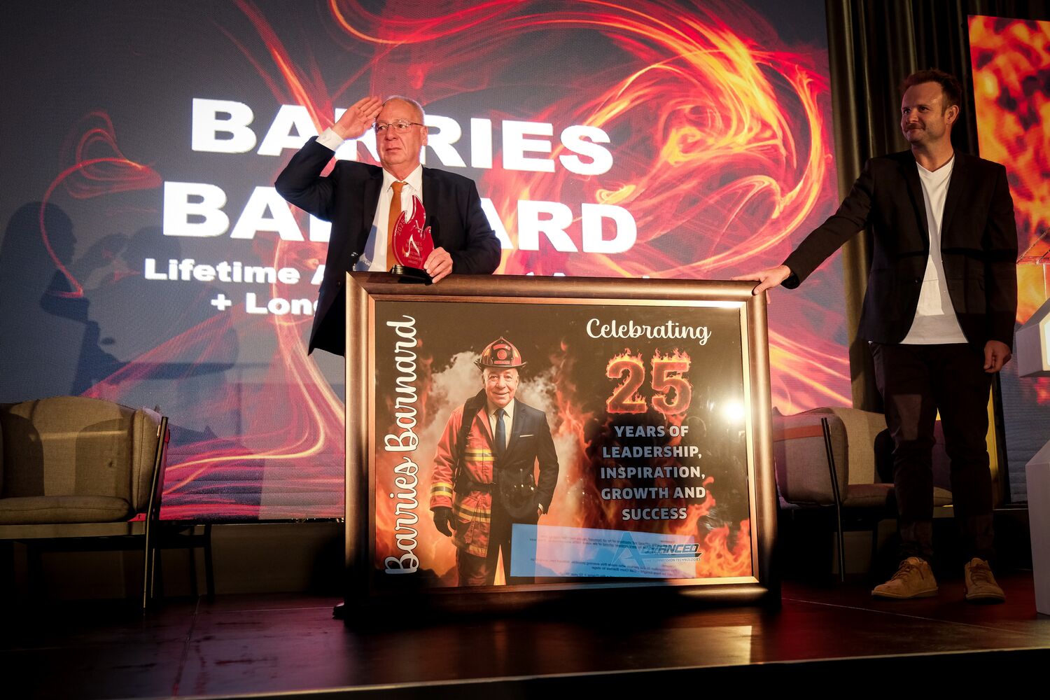 Employees presenting Barries Barnard with a commemorative portrait