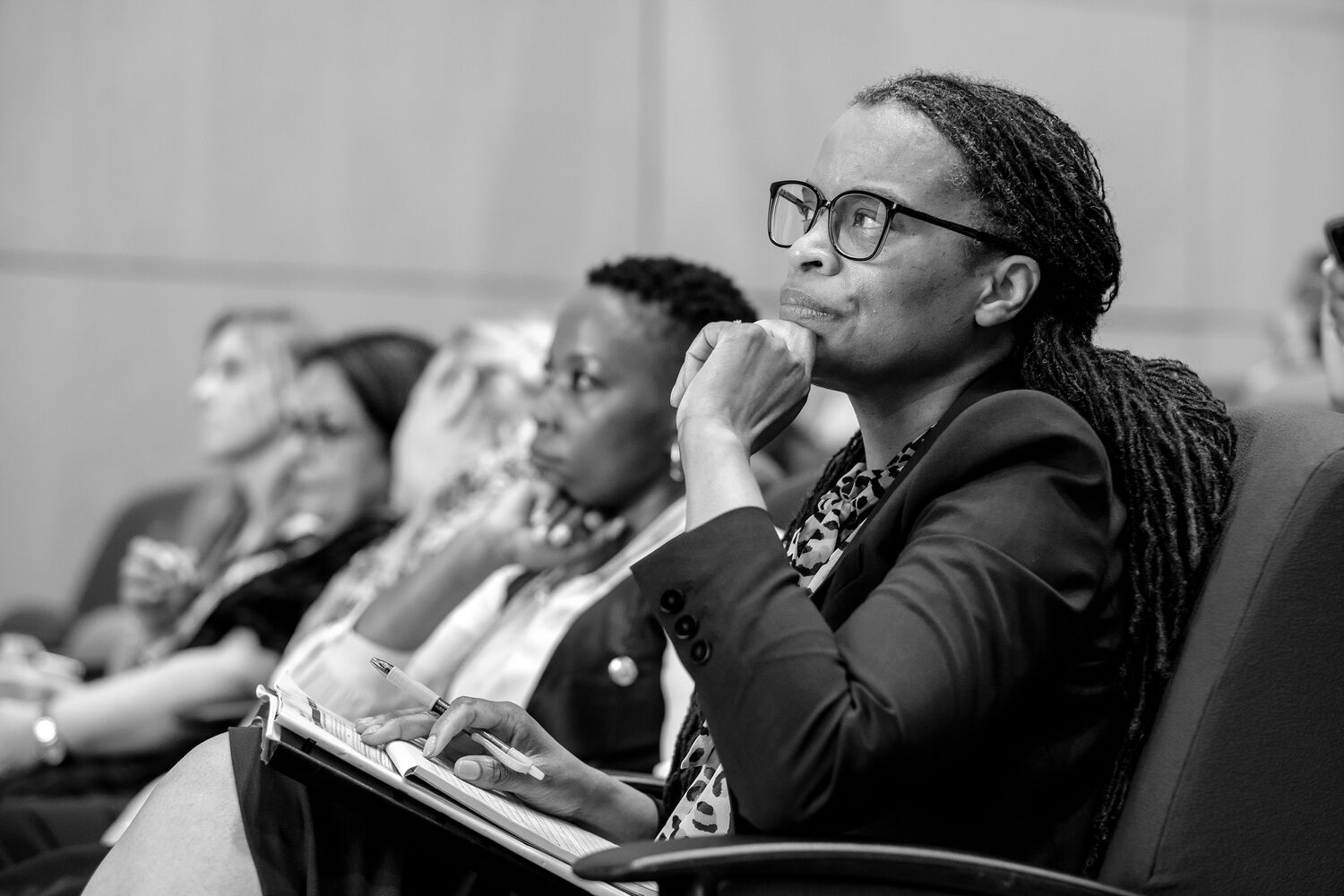 A delegate taking notes during a session