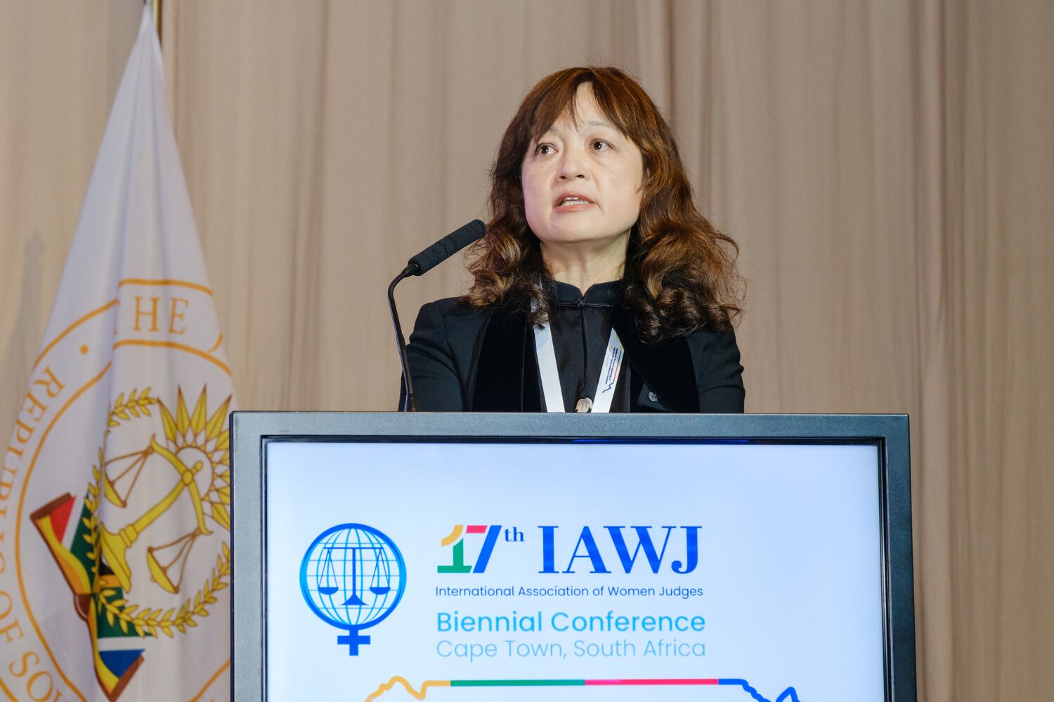 A speaker at the podium during the conference