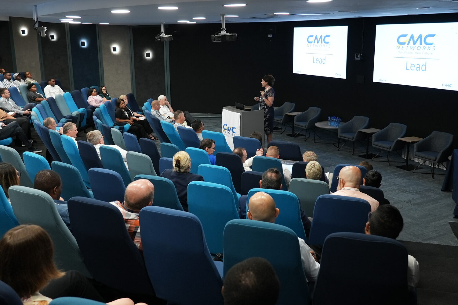 Delegates in the auditorium with CMC Ignite branding