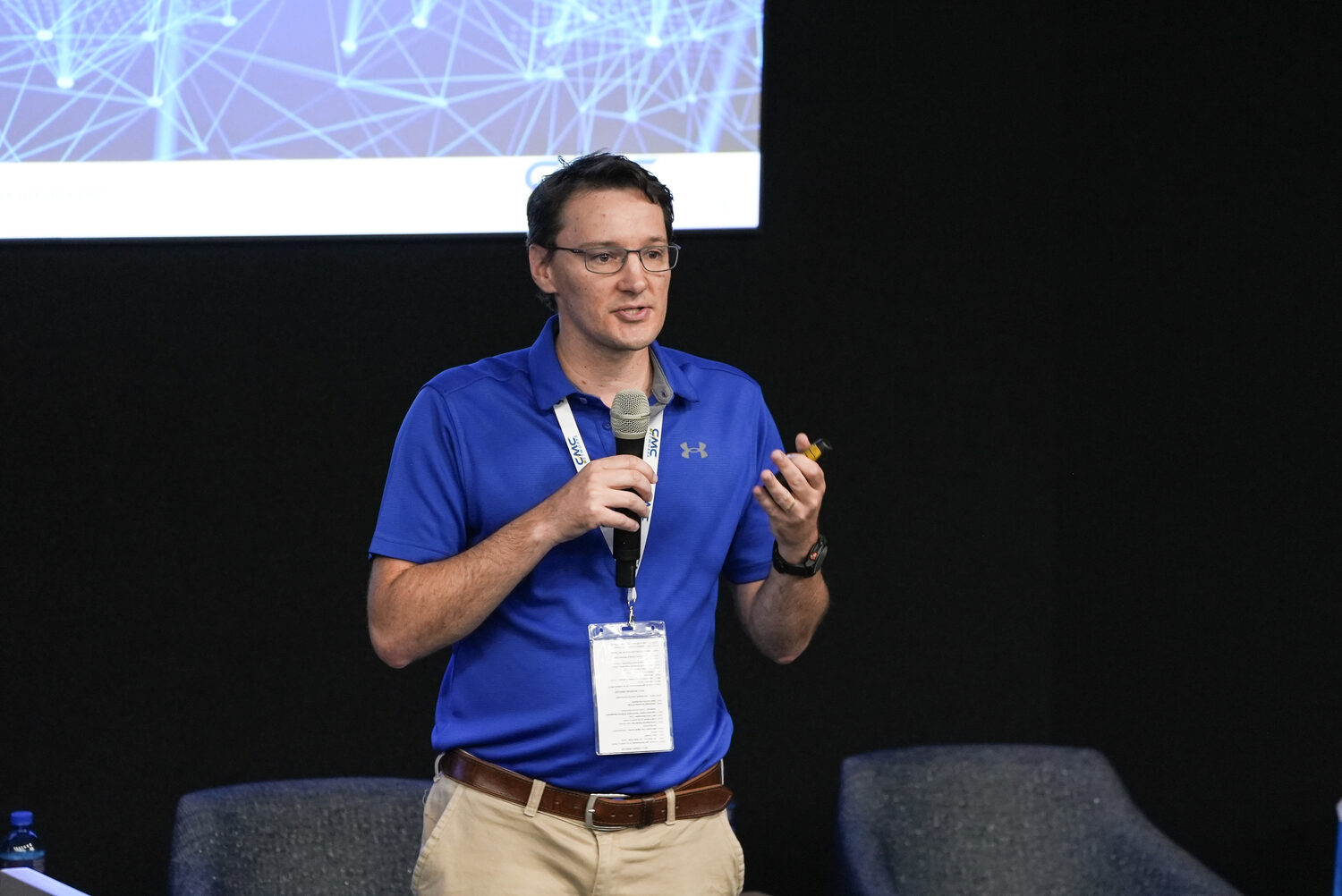 An employee speaking with a microphone at Ignite 2024
