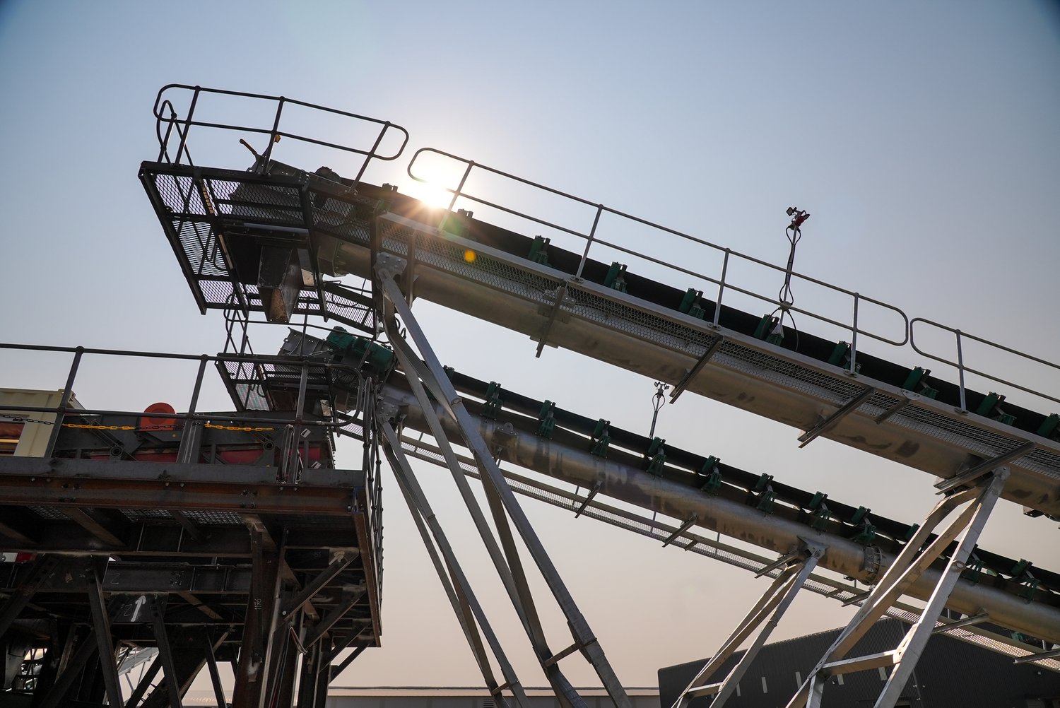 A conveyor structure silhouetted against the sky