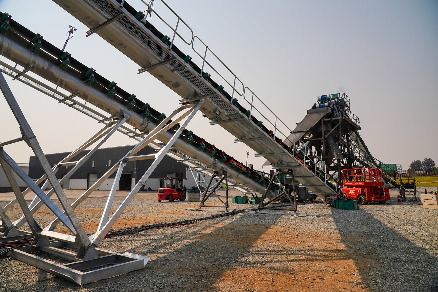 The sorting plant and feed conveyor in late-afternoon light