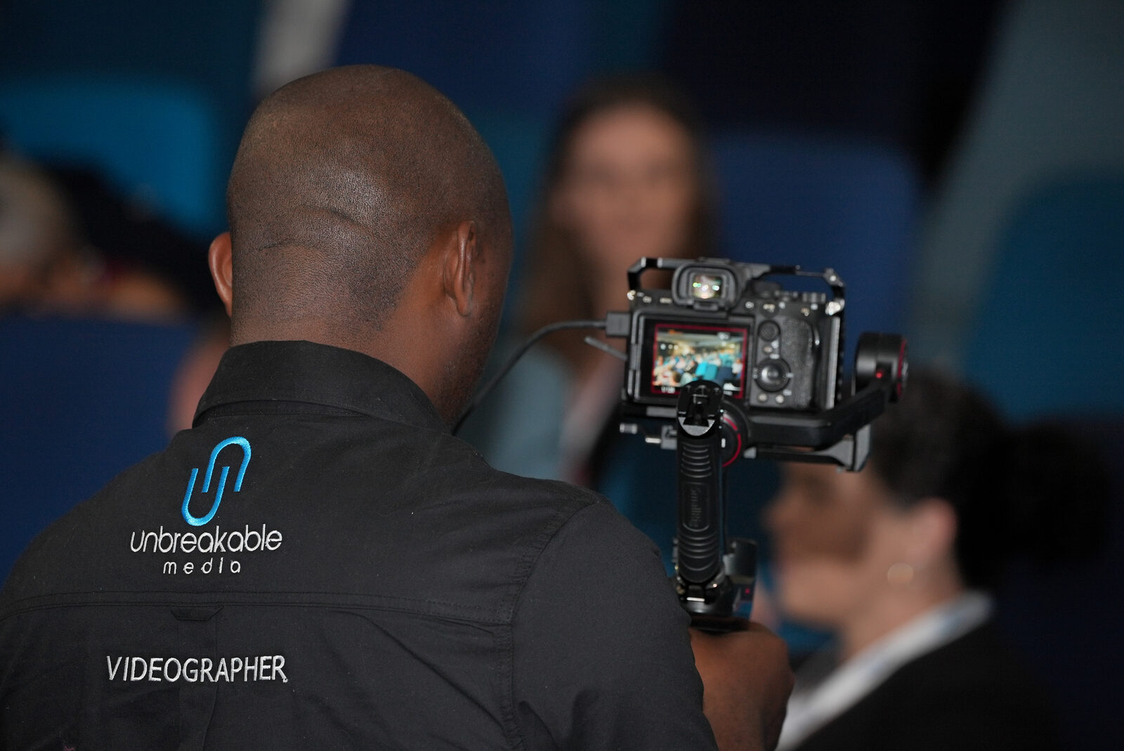 Unbreakable Media videographer filming the conference