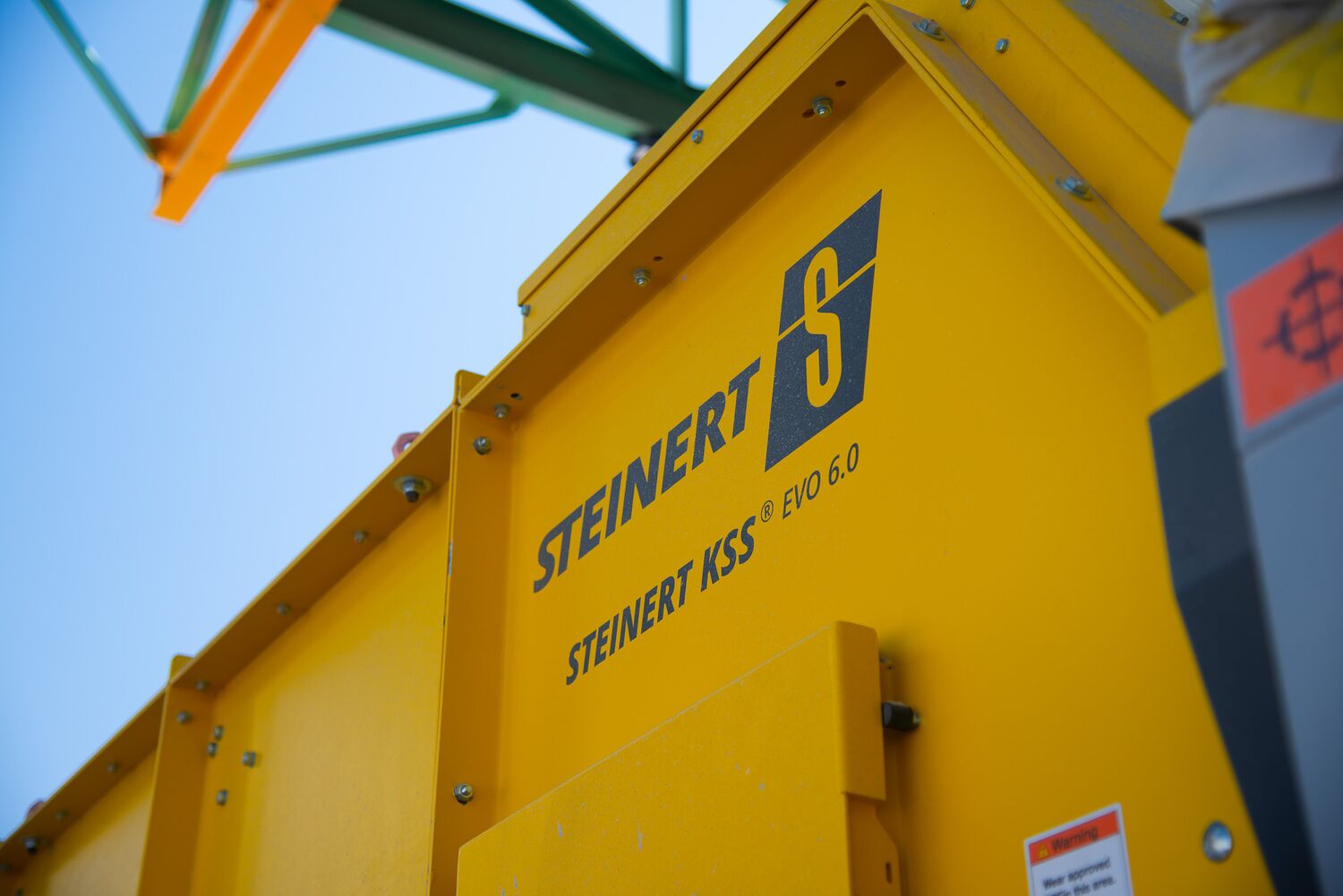 The yellow STEINERT KSS EVO 6.0 sorting system against a blue sky