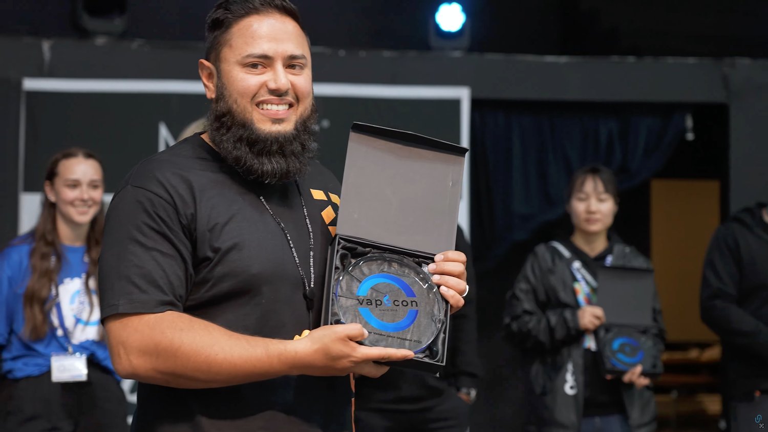 A competition winner receiving a prize at VapeCon