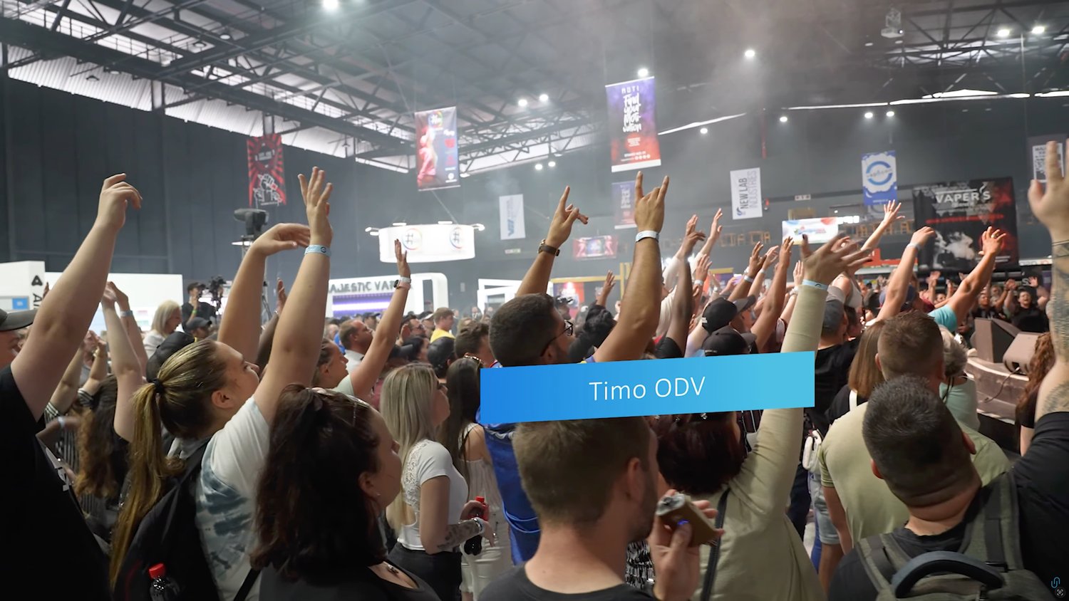 The crowd with hands raised during a VapeCon competition