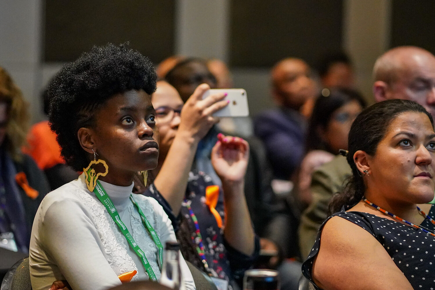 A delegate photographing a session on her phone