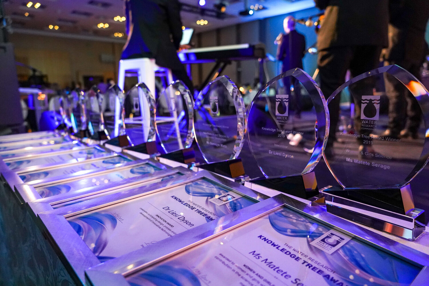 Engraved award trophies displayed on a table