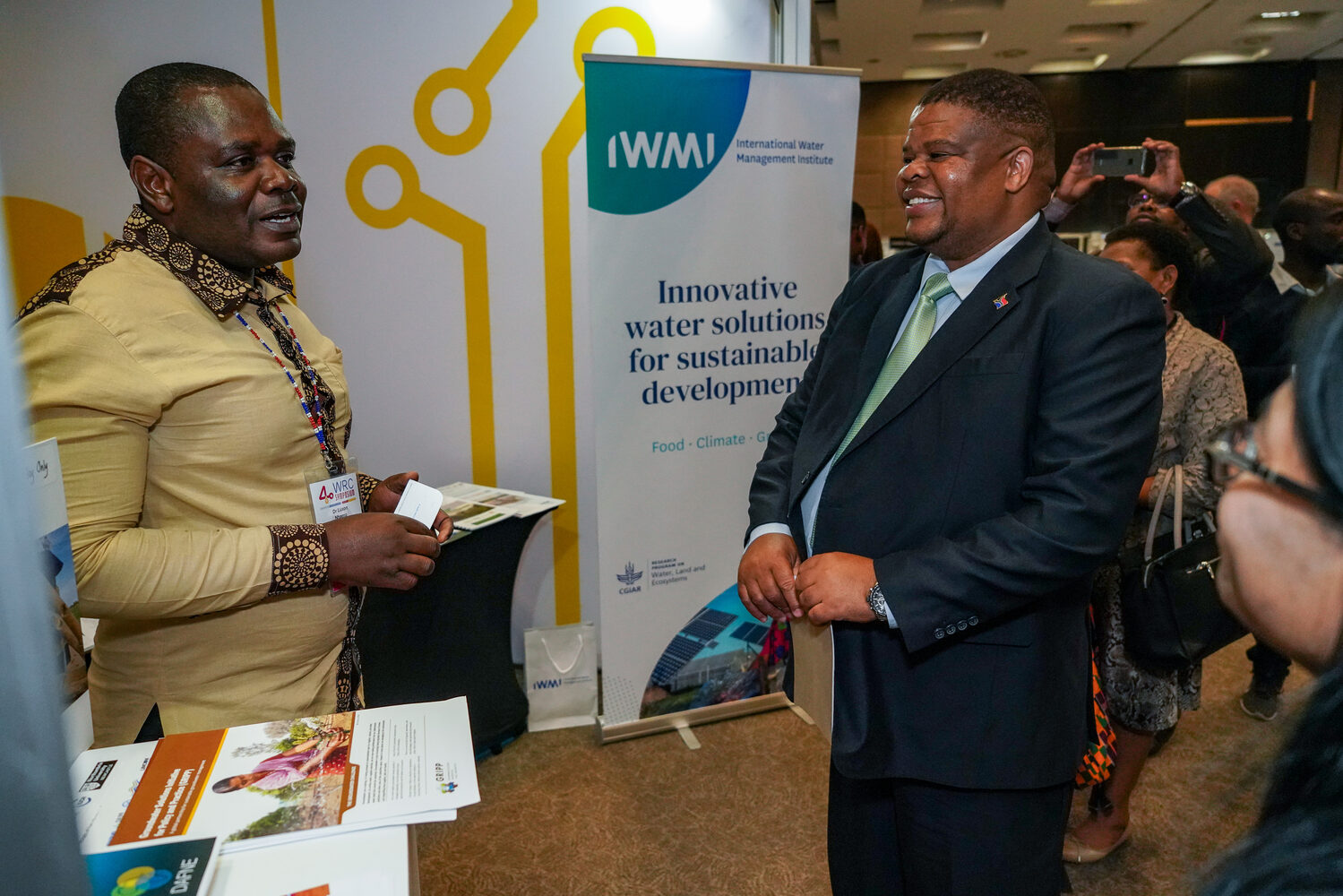Delegates at an exhibition stand during the symposium