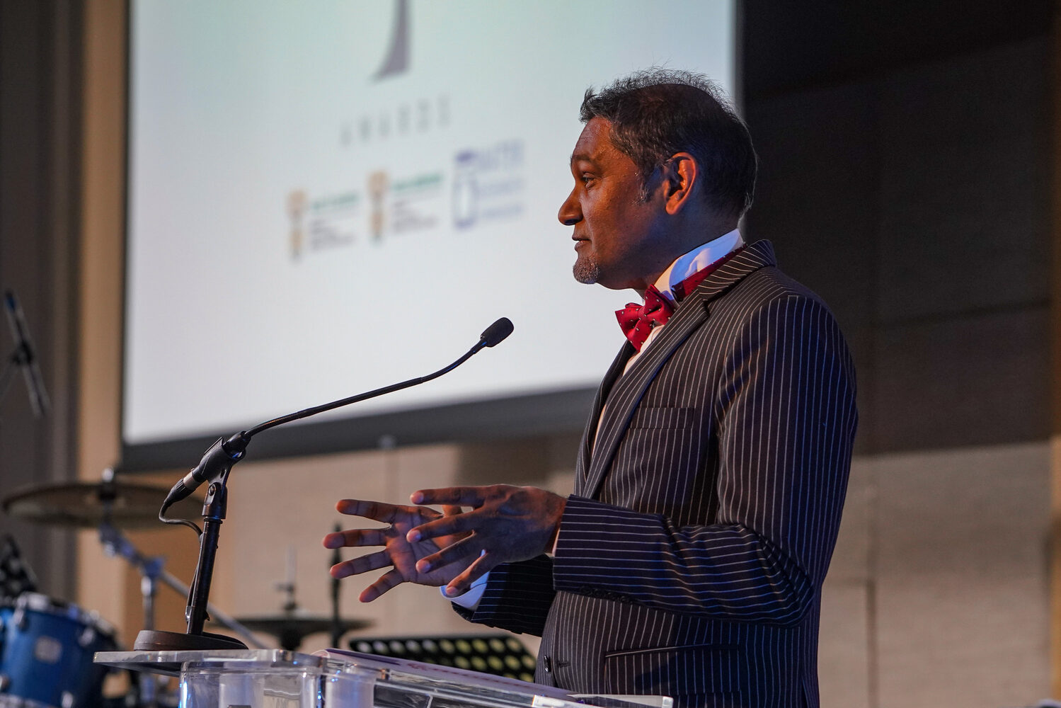 A speaker addressing the symposium from the podium