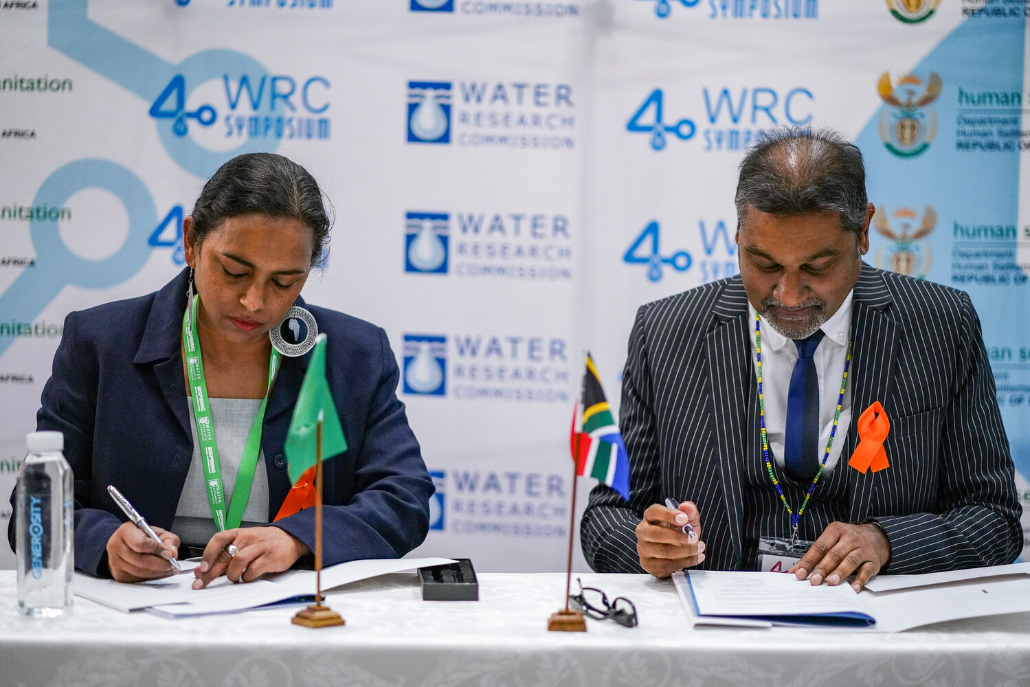 A partnership signing in front of the Water Research Commission branding
