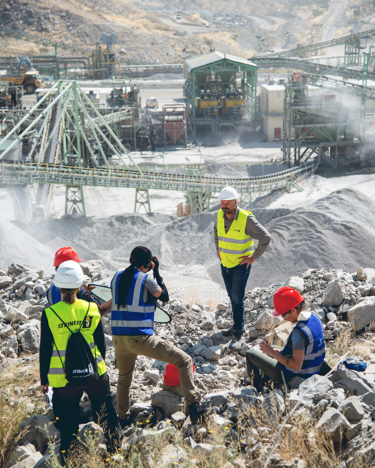 Unbreakable Media crew in high-visibility gear filming on location at an industrial mining site