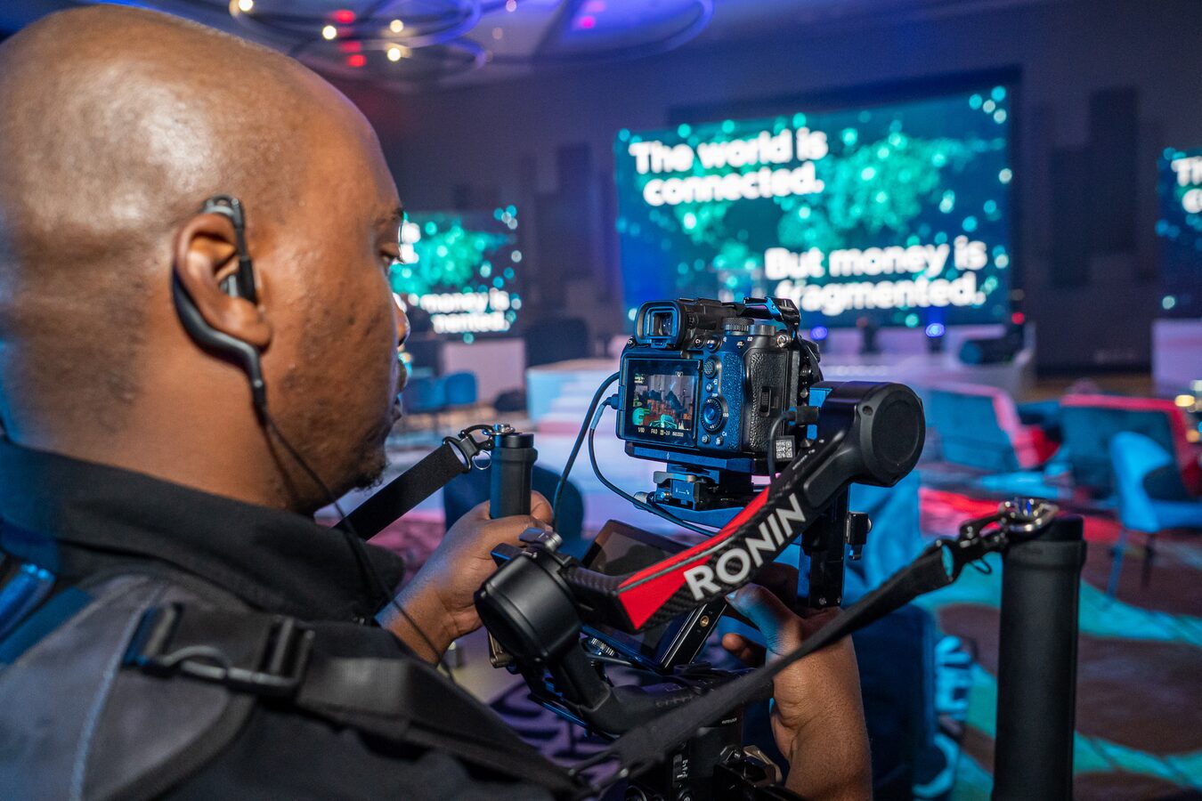 Operator filming with a Ronin-stabilised camera at a corporate event