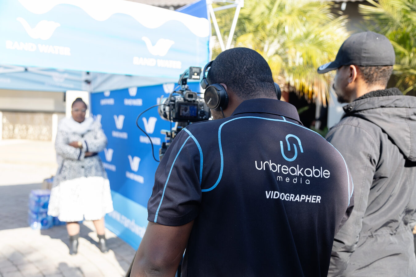 Unbreakable Media videographer filming at a Rand Water outdoor event